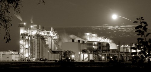 A natural gas power plant on a moonlit night.